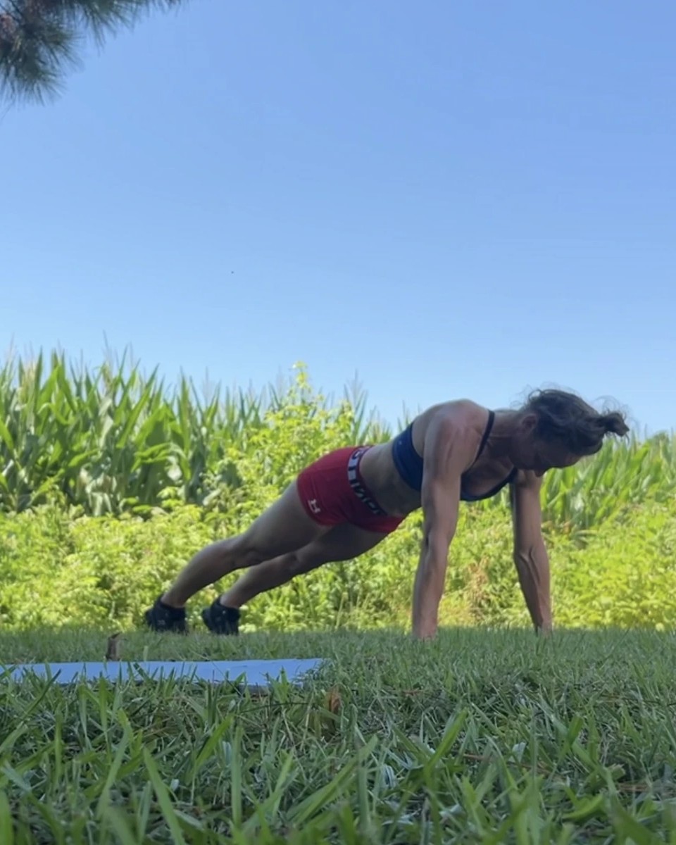 Cal holding a plank in the grass